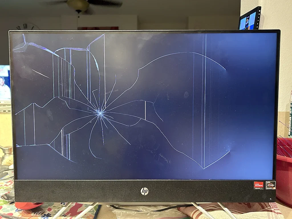 HP all-in-one computer with a cracked screen