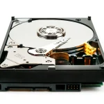 Opened hard drive showing the platter and read arm
