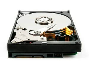 Opened hard drive showing the platter and read arm