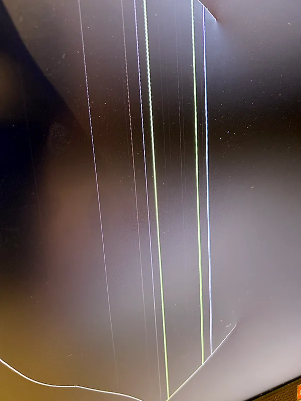 Damaged display showing colored vertical lines and a crack along the edge