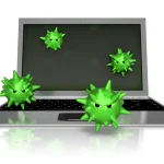 Laptop with green virus icons on the screen